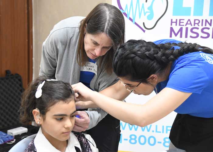 Hearing the Call Humanitarian trip to Jordan 2022 - Child getting fitted with new hearing aids